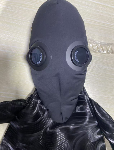 Alien with black fingerprints, discolored face and big eyes